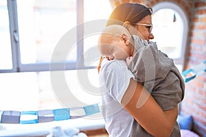 Young beautifull woman and her baby standing on the floor at home