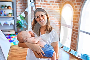 Young beautifull woman and her baby standing on the floor at home