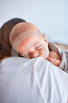 Young beautifull woman and her baby standing on the floor at home photo