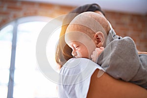 Young beautifull woman and her baby standing on the floor at home photo