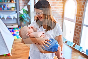 Young beautifull woman and her baby standing on the floor at home photo