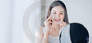 Young Beauty Asian Woman Cleaning Face with Cotton Her Looking at Mirror