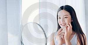 Young Beauty Asian Woman Looking at Mirror Check Clear Face