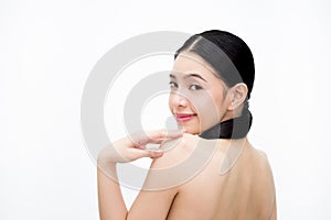 Young beauty Asian woman turning smiling face and showing bare back isolated over white background