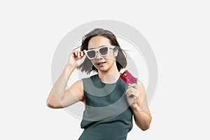 Young beauty Asian woman wearing sunglasses and showing credit card blank card on white isolate background