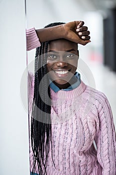 Young beauty relaxed afro american woman smile standing on panoramic windows background