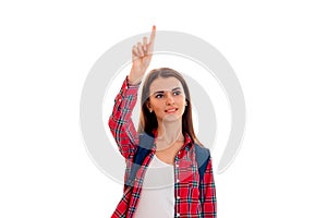 Young beauty student girl with backpack posing isolated on white background in studio