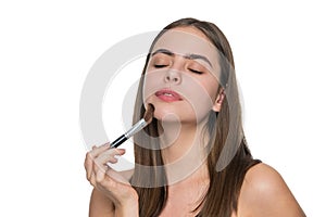 Young beauty woman apply makeup powder on skin with brush isolated on white