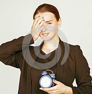 Young beauty woman in business style costume waking up for work early morning on white background with clock drinking