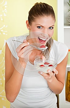 Young beauty woman eating pulp with strawberry
