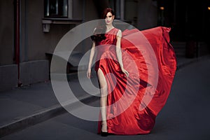 Young Beauty Woman In Fluttering Red Dress