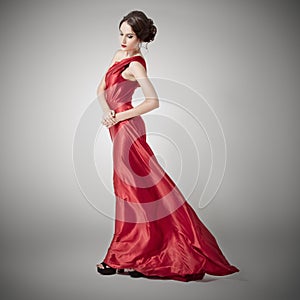 Young beauty woman in fluttering red dress.