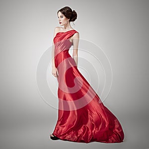 Young beauty woman in fluttering red dress.