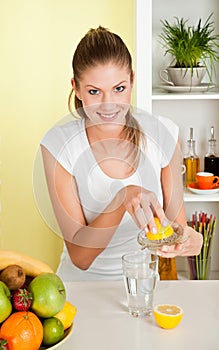 Young beauty woman make lemon juice