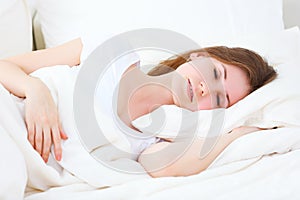 Young beauty woman sleeping in bed