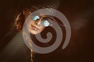 Young beauty woman in steampunk round glasses