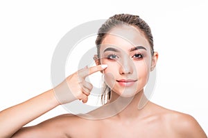Young beauty woman who checks her skin. Cosmetology, skin care, acne treatment.