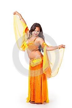Young belly dancer in yellow and orange costume