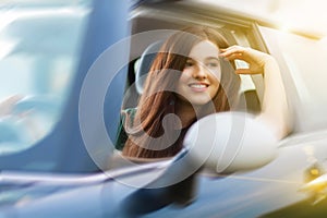 Young beuatiful woman driving a car