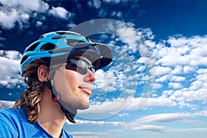 Young bicyclist in helmet and glasses