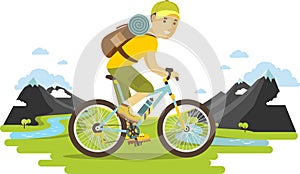 Young bicyclist man riding a bike on mountain background
