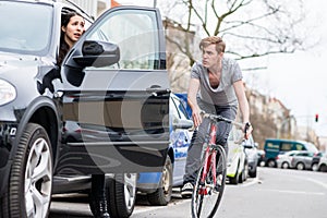 Young bicyclist shouting while swerving for avoiding dangerous collision