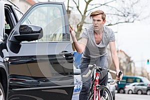 Young bicyclist shouting while swerving for avoiding dangerous collision photo