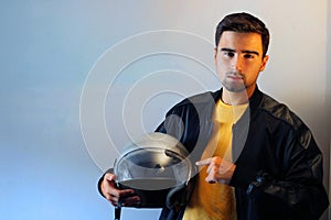 Young biker with a gray motorcycle helmet