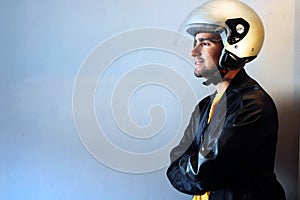 Young biker with a gray motorcycle helmet on
