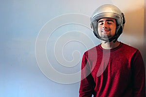 Young biker with a gray motorcycle helmet on