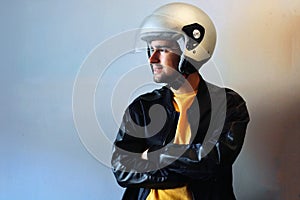 Young biker with a gray motorcycle helmet on