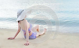 Young bikini girl with hawaii hat