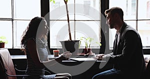 Young biracial woman answering questions of recruiter.