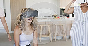 Young biracial women enjoy virtual reality at home
