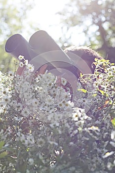 Young bird watcher holding binoculars