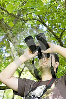 Young bird watcher holding binoculars