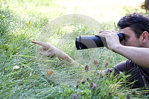 Young bird watcher holding binoculars