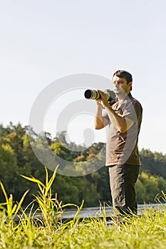 Young bird watcher with photo camera