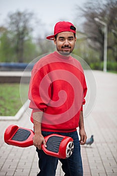 Young black boy with electric mini segway hover board scooter