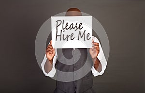 Young Black Business Man holding Please Hire Me Sign