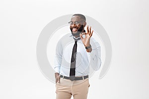 Young black businessman having happy look, smiling, gesturing, showing OK sign. African male showing OK-gesture with his