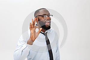 Young black businessman having happy look, smiling, gesturing, showing OK sign. African male showing OK-gesture with his