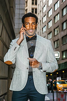 Young black businessman talking on cell phone on street in New York City
