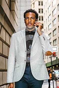 Young black businessman talking on cell phone on street in New York City