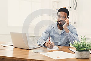 Young black businessman talking on mobile phone