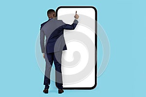 Young Black Businessman Using Huge Blank Smartphone With White Screen