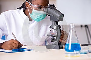 The young black chemist working in the lab