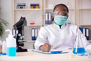 Young black chemist working in the lab