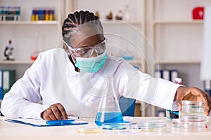 Young black chemist working in the lab