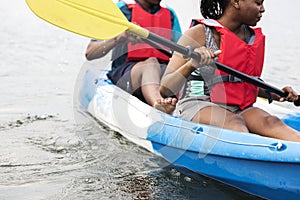Young black couple canoeing in a lake